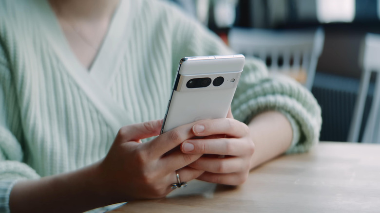 Someone using a Pixel 7 Pro while sitting at a table