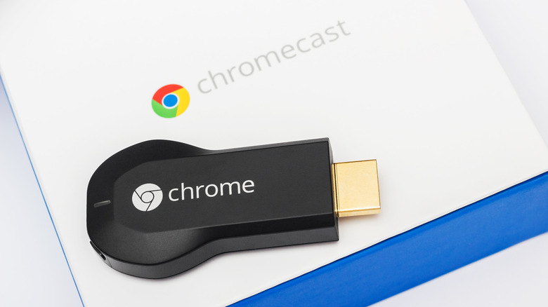 An old Chromecast HDMI-dongle next to its packaging