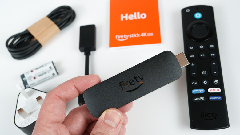 An unboxed Amazon Fire Stick 4K that includes accessories