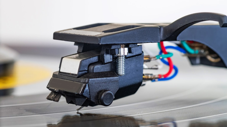 Closeup of a record player needle scratching reading the grooves of a record