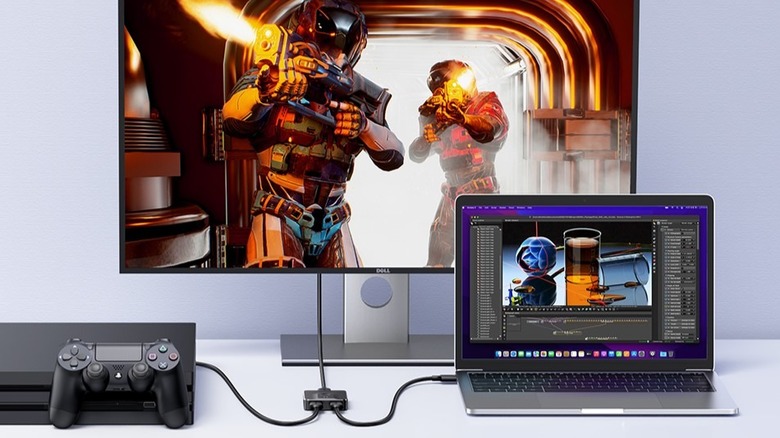 A Ugreen HDMI switch used to connect a game console and a laptop to a single display.