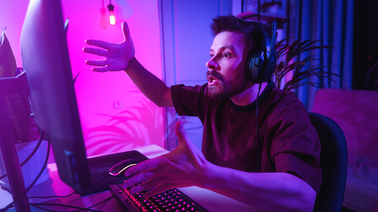 Person looking visibly upset while sitting in front of a PC