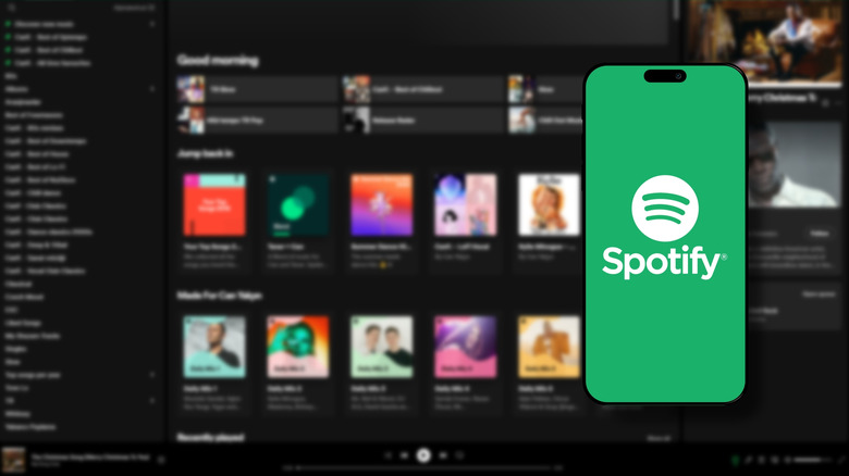 Spotify logo on phone screen in front of out of focus web app