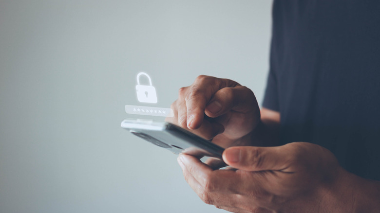 Person using phone with lock graphic above indicating privacy issues