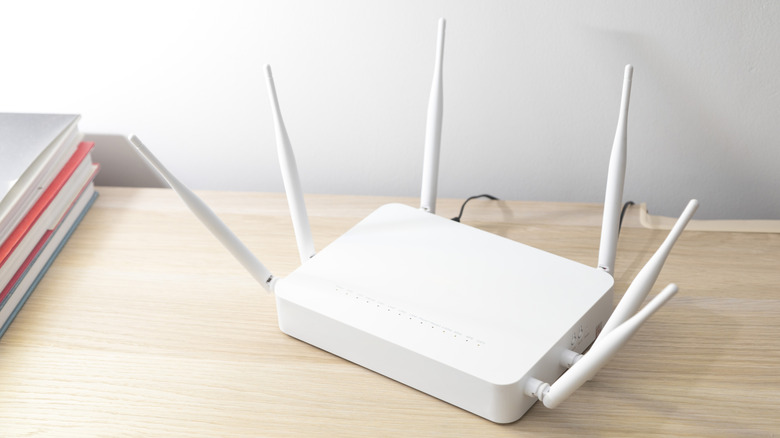 Wireless router on a shelf in a home with antennas extended.