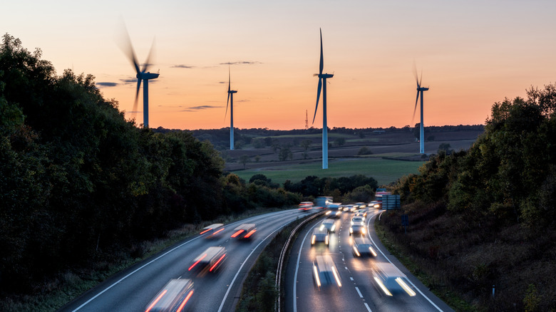 Wind turbines operating next to a highway