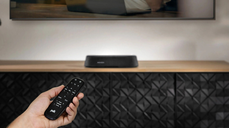 A small Polk Audio soundbar set up on a TV stand in a modern living room.