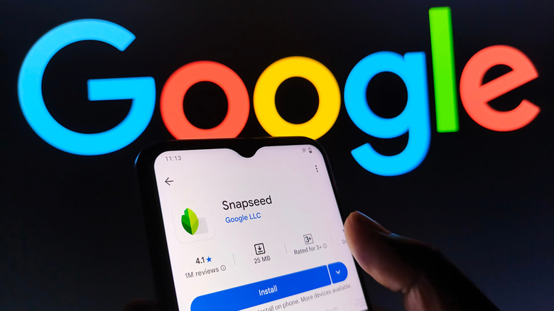 The Snapseed app in the Google Play Store with the Google logo on the wall behind it
