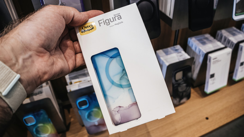 OtterBox in box held in hand near store shelves