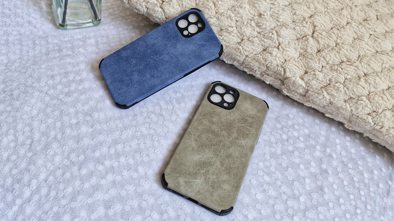 Suede backed phone cases laying on white cloth