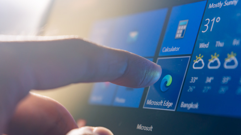 a person touching microsoft edge on a windows computer