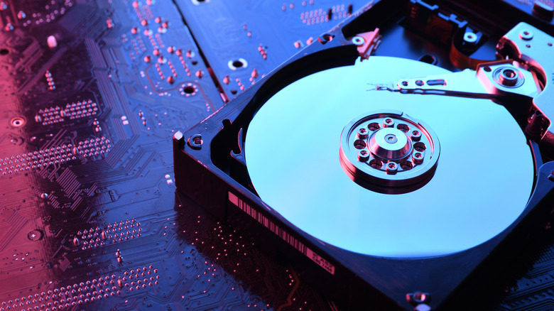 an exposed hdd drive sitting on a circuit board