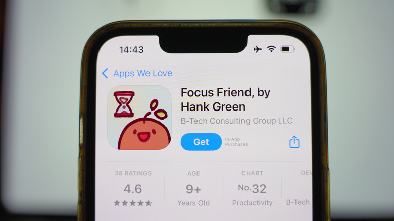 An iPhone centered in the image displaying Focus Friend, by Hank Green within the Apple App Store