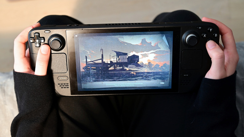 a person playing on a steam deck on their lap