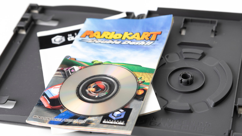 a copy of the Mario Kart GameCube game with disc and game box opened