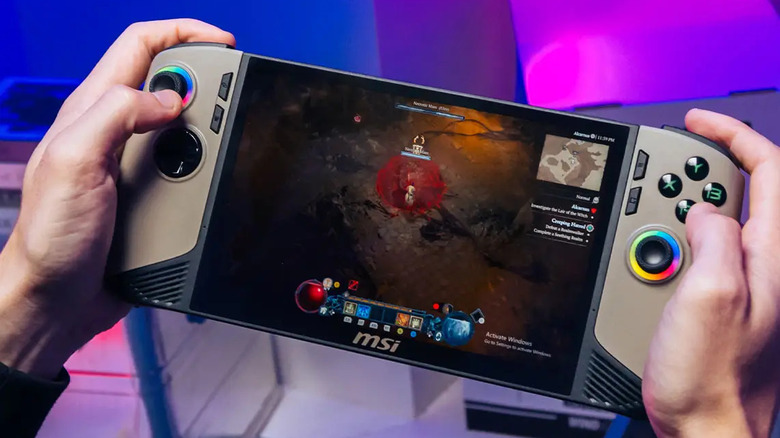 Person holding MSI Claw 8 AI+ with a game being played on the screen