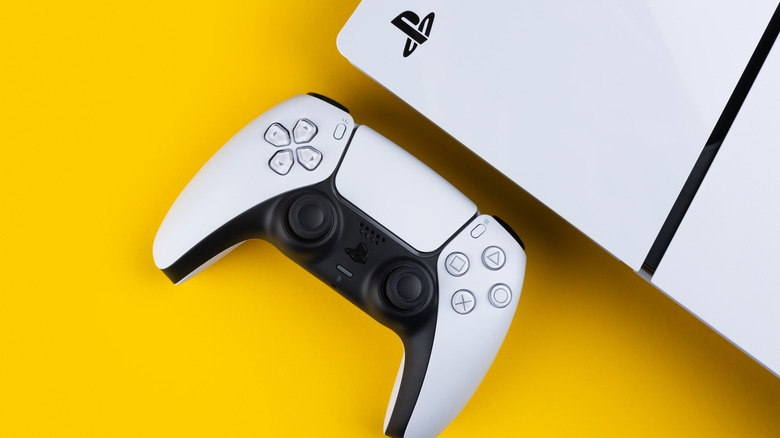 A PlayStation 5 over a yellow background.