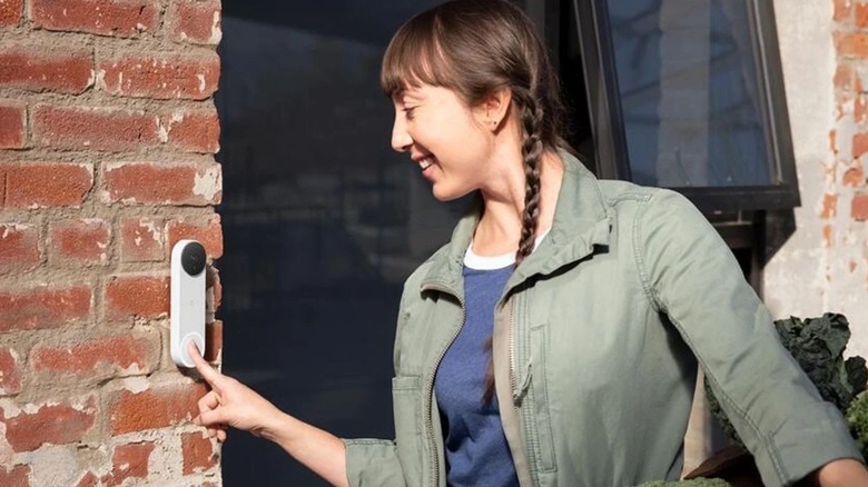 A person ringing a Google Nest doorbell