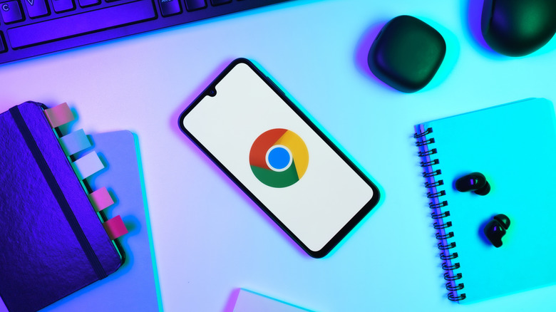 An Android phone with the Chrome icon placed on a desk
