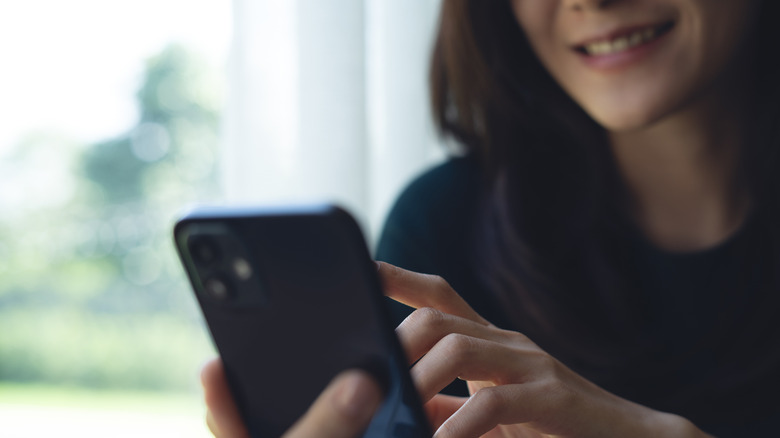 Close up of a person searching on an iPhone