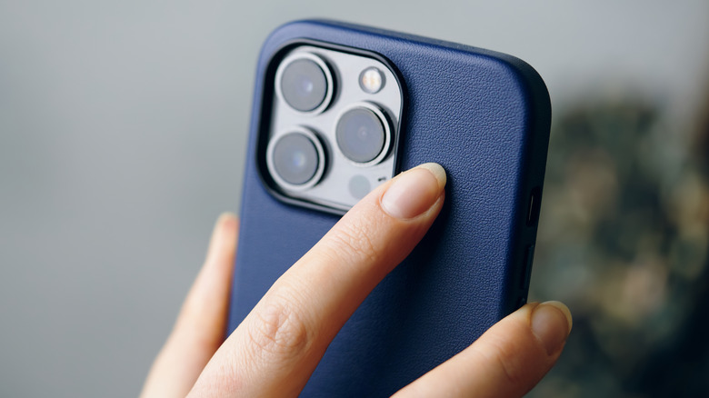 Person holding up iPhone to use back-facing camera