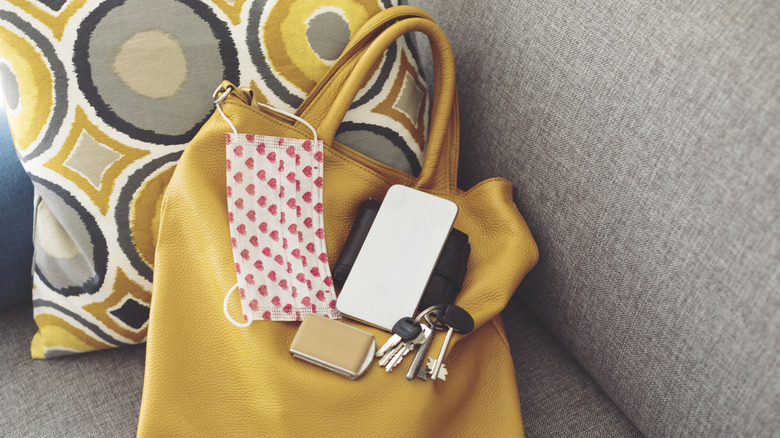 A handbag with multiple items kept on it
