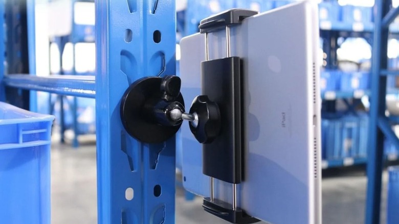 A tablet attached to a metal surface using the CANHET Magnetic Tablet Holder