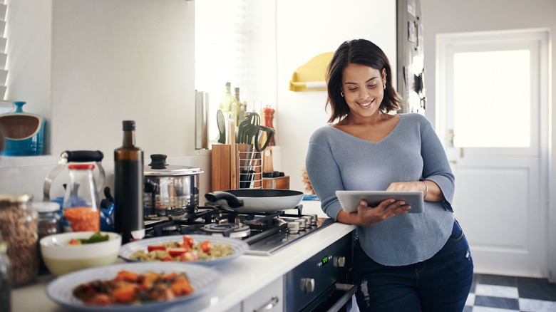 person using tablet in kitchen