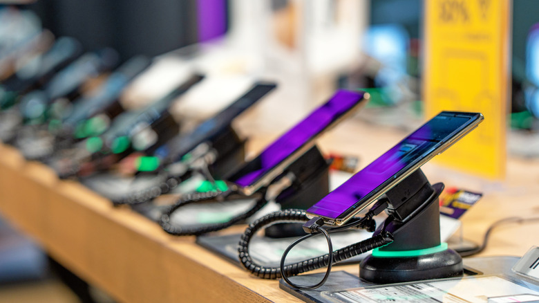 Various smartphones on display in a store