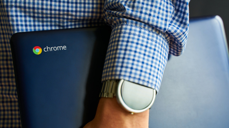 A person holding an ASUS Chromebook.