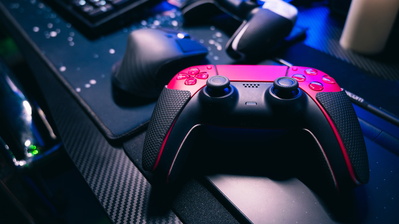 a red DualSense controller sitting on a table