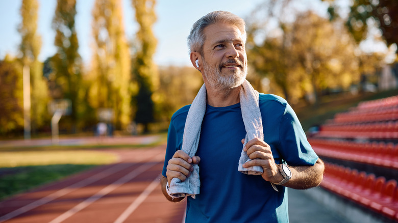 Older man wearing earbuds after working out