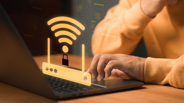 Concept of a Wi-Fi router with a lock icon placed atop a laptop