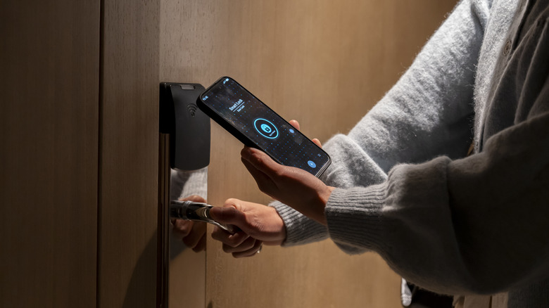 Person unlocking door with phone