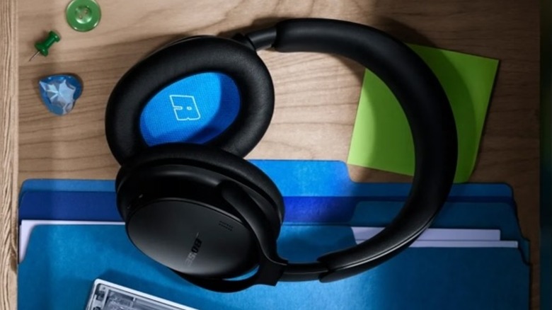 A pair of black, second-generation Bose QuietComfort Headphones sit in a dresser drawer
