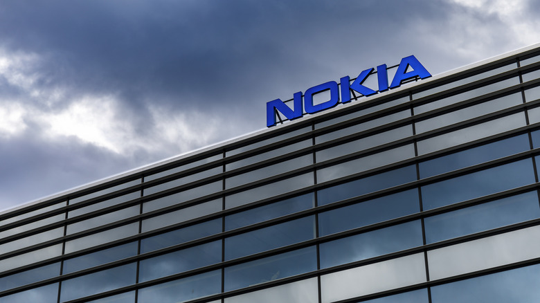 Glass building with Nokia logo on top with blue sky behind