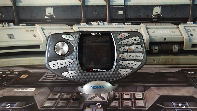 Nokia N-Gage with screen off sitting on stand on desk