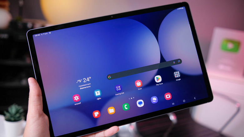 Hand holding a Samsung Galaxy S10+ tablet
