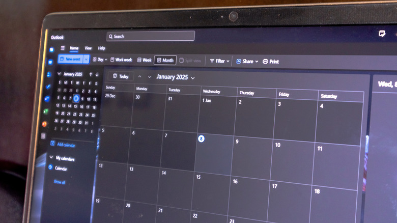 Photo of Outlook Calendar application on laptop screen showing month view