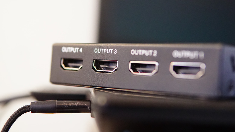 Close-up of an HDMI splitter with four output ports