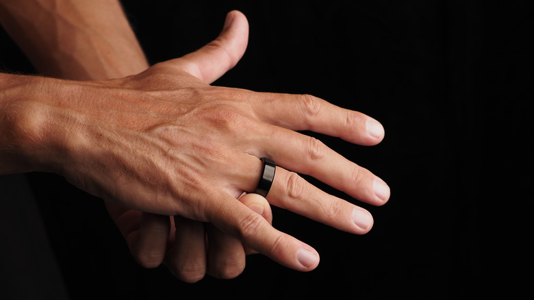 Close-up of a person's hands wearing a smart ring