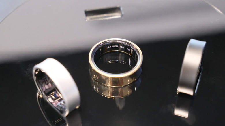 Three Samsung Galaxy Ring smart rings on a black surface