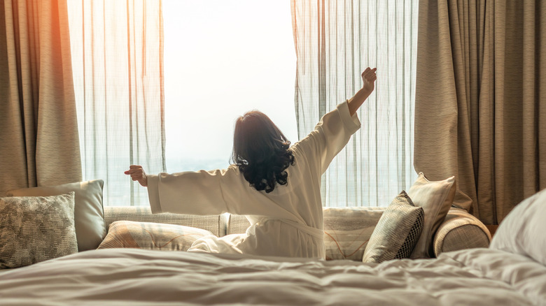 Stretching in front of a sunrise coming through a window