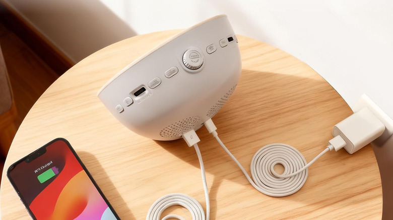 The Stillstorm Hatch connected to a wall outlet and an iPhone