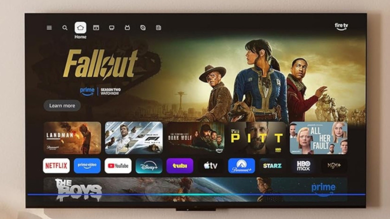 An Amazon-branded Fire TV wall-mounted in a living room.