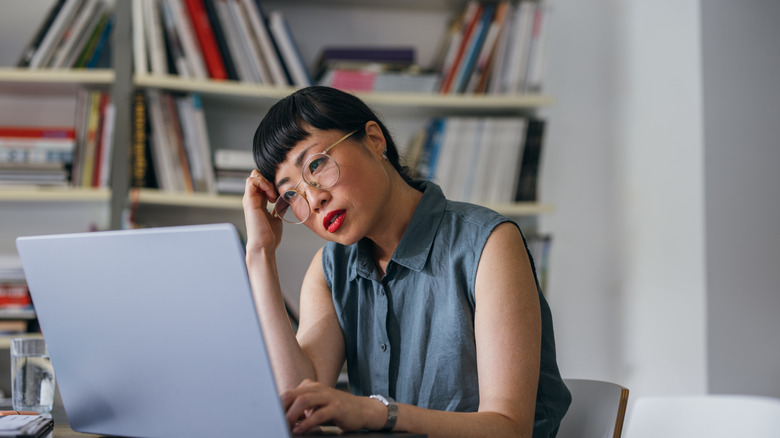 Person looking sad at computer