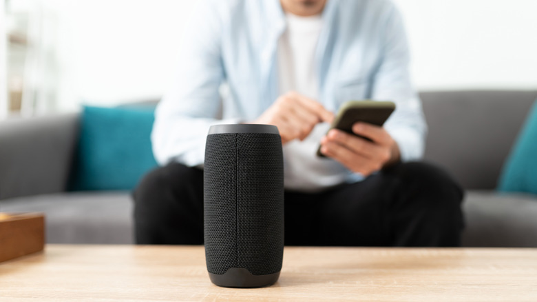 Close-up of a person connecting their smartphone to a bluetooth speaker