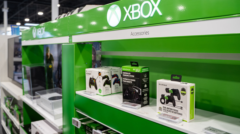 Xbox console gaming accessories on a store shelf, controller charging port and more