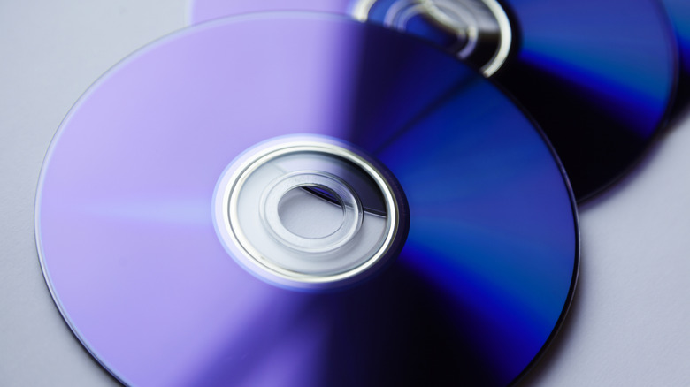 Discs piled on top of a flat surface.
