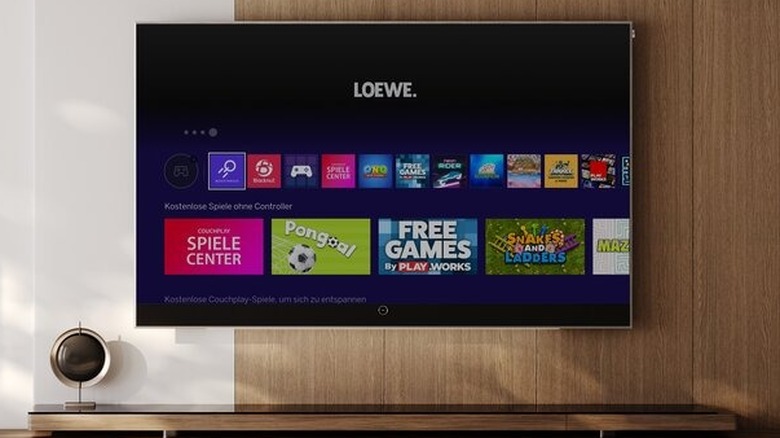 A Loewe Stellar 97-Inch DR+ OLED Smart TV mounted on a wall